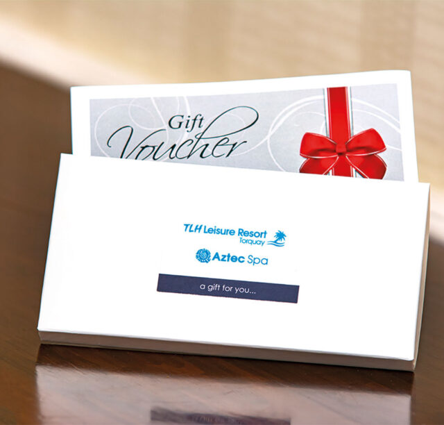 A small cardboard box, with the TLH and Aztec Spa logo on the front for gift vouchers.